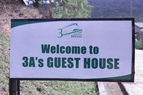 a sign for a welcome to guest house at 3A's Guest House in Oko Sombo