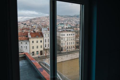 a view of a city from a window at Amazing Penthouse old town in Sarajevo