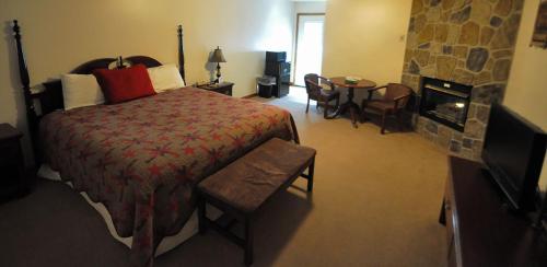 a bedroom with a large bed and a fireplace at Bear Camp By The Night in Pigeon Forge