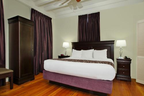 a bedroom with a large bed with white sheets at Lamothe House Hotel a French Quarter Guest Houses Property in New Orleans