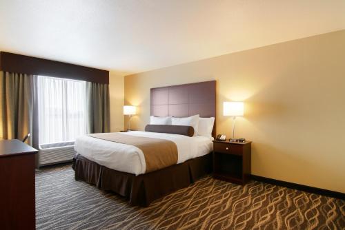 a hotel room with a large bed and two lamps at Cobblestone Inn & Suites - Menomonie/UW-Stout in Menomonie