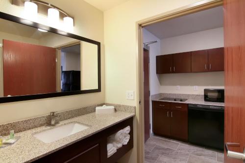 a bathroom with a sink and a mirror at Cobblestone Inn & Suites - Menomonie/UW-Stout in Menomonie
