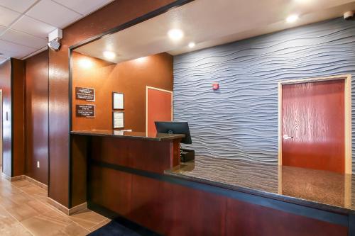 a reception desk in a hospital lobby with a wave painted on the wall at Cobblestone Inn & Suites - Menomonie/UW-Stout in Menomonie