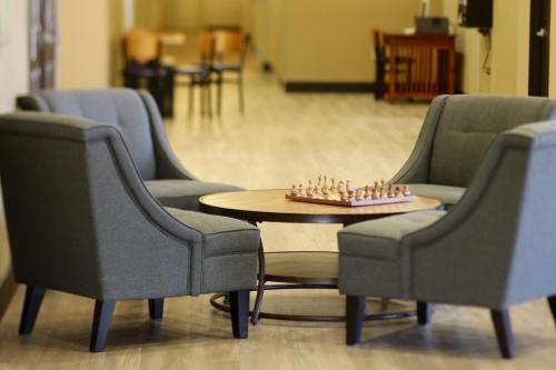 a room with chairs and a chessboard on a table at MainStay Suites Fitchburg - Madison in Madison