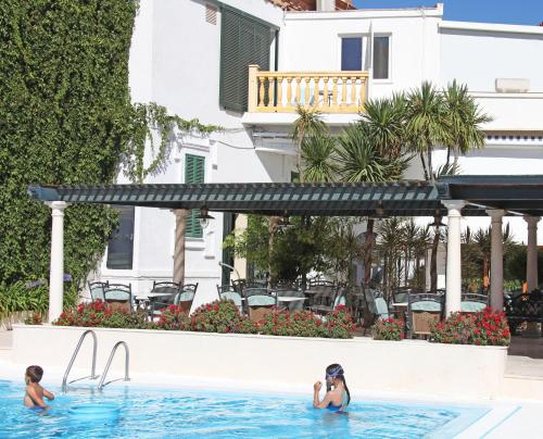 two women in the swimming pool at a resort at Al Sur de Chipiona in Chipiona