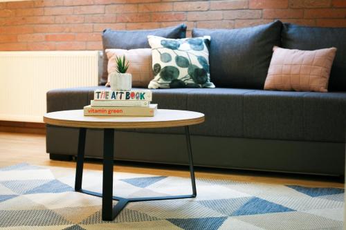 a living room with a couch and a coffee table at Apartmani Mursa in Osijek