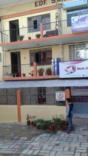 a man standing in front of a building at Qoricancha B&B Cusco in Cusco