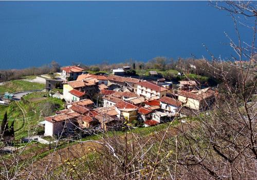 a group of houses on a hill with the water at Foresteria La Ceriola in Monte Isola