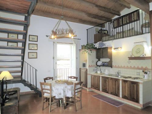 a kitchen with a table and chairs in a room at La Casa Delle Fate in Siracusa