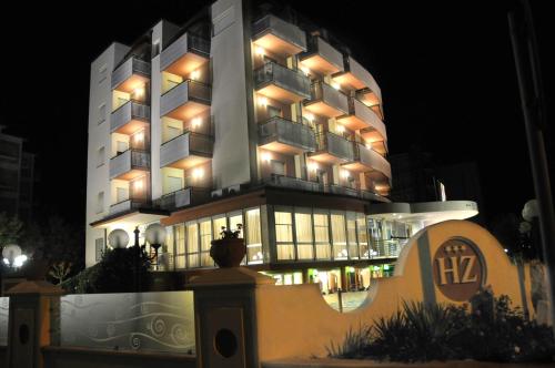 a large building with lights on it at night at Hotel Zenith in Cervia