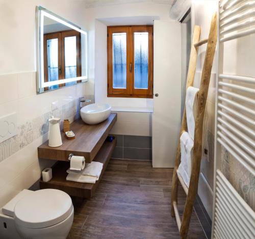 uma casa de banho com um WC branco e um lavatório. em Al Rost B&B em Luino