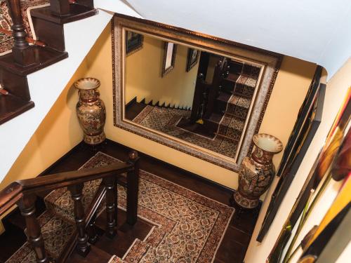 a stairway with a mirror and a fireplace at Casa das Andorinhas in Ponte de Lima