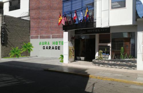 a hotel with flags on the front of a building at Aura Hotel in Chiclayo