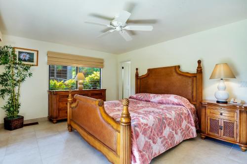 a bedroom with a bed and a ceiling fan at Castle Kanaloa at Kona in Kailua-Kona