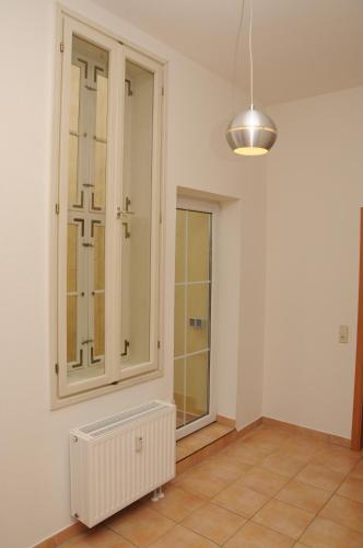 a room with a cabinet and a tile floor at Apartments am Brunnen in Quedlinburg