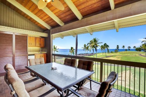 a screened in porch with a table and chairs at Castle Kanaloa at Kona in Kailua-Kona
