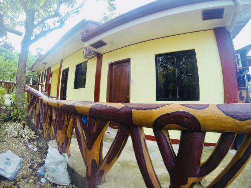 a house with a wooden fence in front of it at La Casa de Samonteza in Camotes Islands
