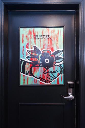 a door with a painting on it with graffiti on it at The Commonwealth in Richmond