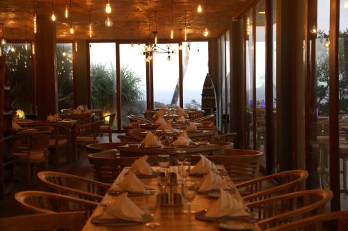 a dining room with tables with napkins on them at Thaproban Pavilion Waves in Unawatuna