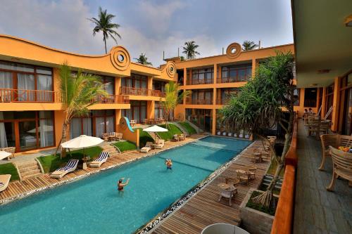 a hotel with a swimming pool and a resort at Thaproban Pavilion Waves in Unawatuna
