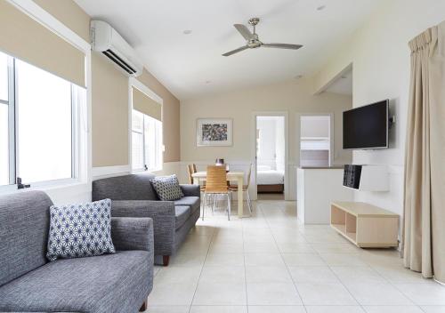 a living room with a couch and a table at NRMA Stockton Beach Holiday Park in Stockton