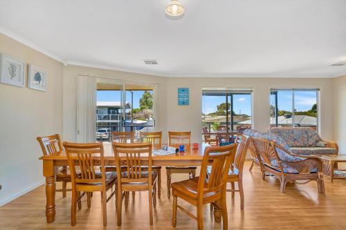 a dining room with a table and chairs at Green Reef Beach House - Aldinga Beach - C21 SouthCoast Holidays in Aldinga Beach