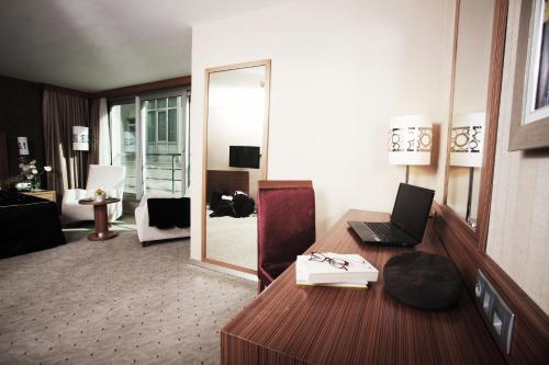 a room with a desk with a laptop on it at Demora Hotel in Ankara