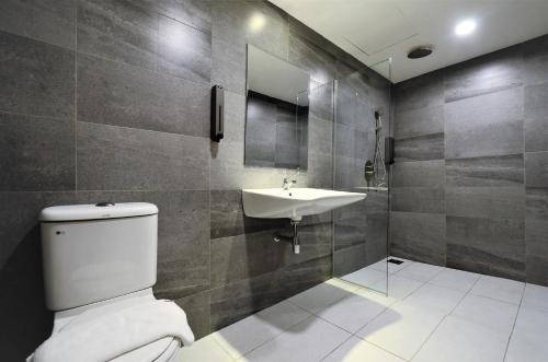 a bathroom with a toilet and a sink at Artisan Eco Hotel in Petaling Jaya