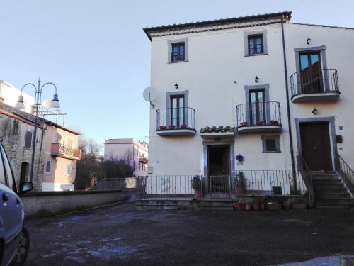 a white house with balconies on the side of it at Il Palazzetto sulla Francigena in Formello