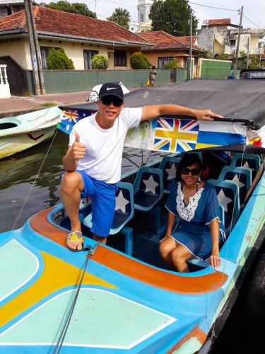 a man and a woman sitting on a boat at Nico Lagoon Hotel in Negombo