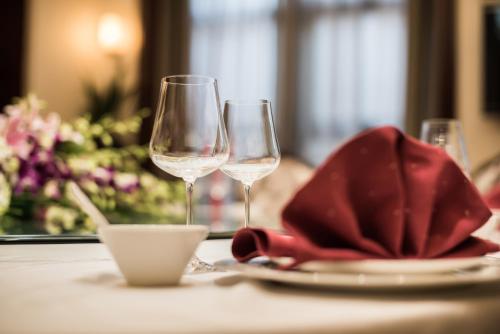 a table with two wine glasses and a napkin at Pullman Beijing South in Daxing