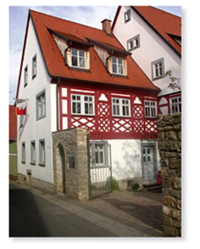 a red and white house with a red roof at Weingut Heim in Obereisenheim