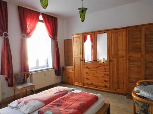 a bedroom with a bed and some windows at Pension Pieschen Dresden in Dresden