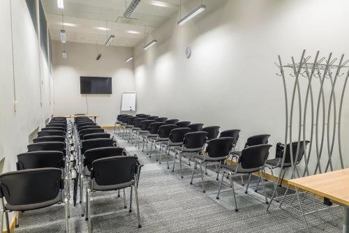 a room with rows of chairs in a classroom at Restart in Rēzekne