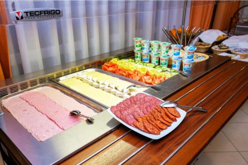a buffet with meat and other food on a table at Harkányi Psoriasis Centrum in Harkány