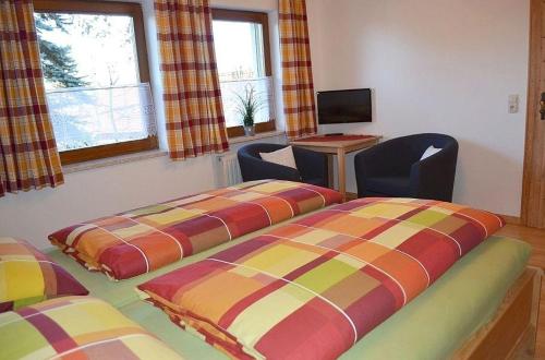 Gotteszell的住宿－FEWO-Kramheller-Gotteszell，客房设有两张床、一张桌子和一台电视。