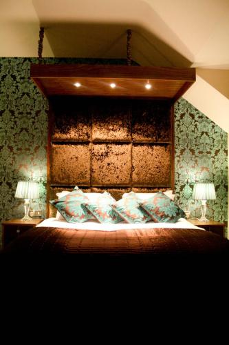 a bedroom with a large bed with two lamps at The Old Barn Inn in Newport