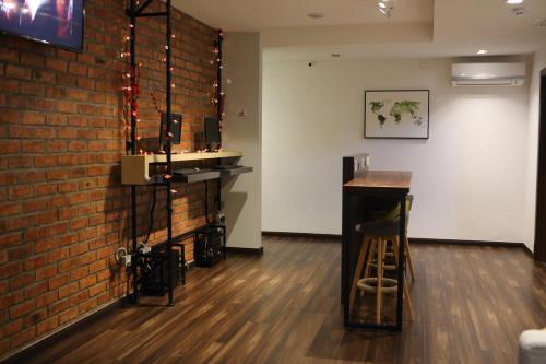 a bar in a room with a brick wall at De House Hotel in Sibu