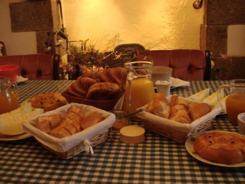 a table topped with trays of bread and pastries at Ty Gwennili in Kérien