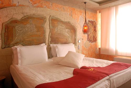 a bedroom with a large bed with a wall at Diplomat Plaza Hotel & Resort in Lukovit