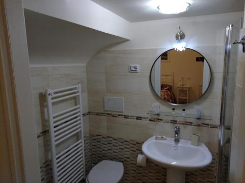 a bathroom with a sink and a mirror at La Maison di Nicoletta in Gaeta
