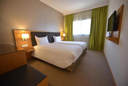 Postel nebo postele na pokoji v ubytování Annakhil Hotel