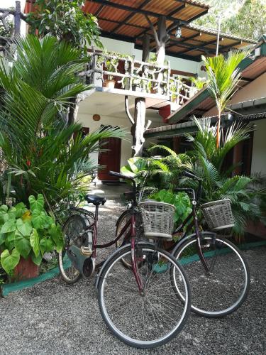 two bikes parked in front of a building at The Nature Park Villa in Sigiriya