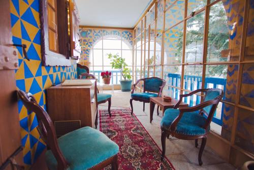 a room with chairs and a table and windows at La Crestolina in Ala di Stura
