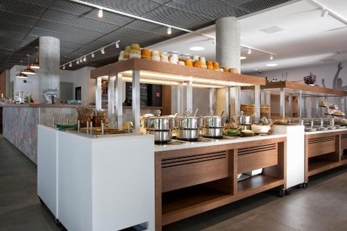 a kitchen with a counter with lots of food at Tallink Express Hotel in Tallinn