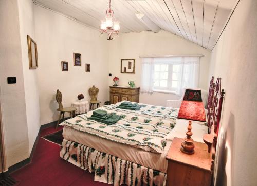 a bedroom with a bed and a table with a lamp at La Crestolina in Ala di Stura