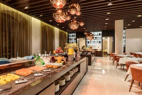 a buffet line in a restaurant with food on display at Áurea Museum by Eurostars Hotel Company in Lisbon