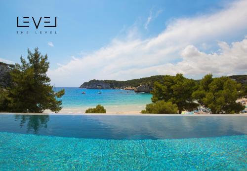 a swimming pool with a view of the beach at Meliá Cala Galdana in Cala Galdana