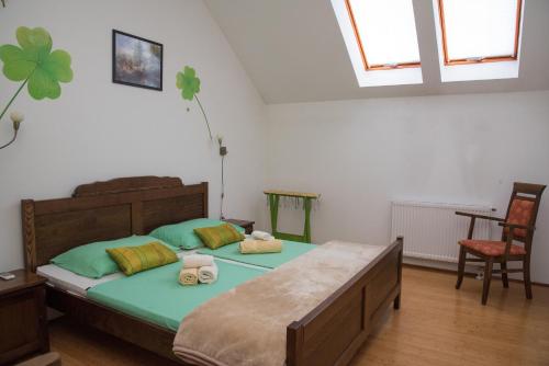 a bedroom with a bed with two towels on it at Smještaj Slavonija in Daruvar