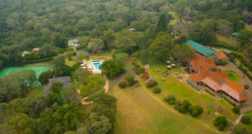 an aerial view of a house with a yard at The Aberdare Country Club in Mweiga